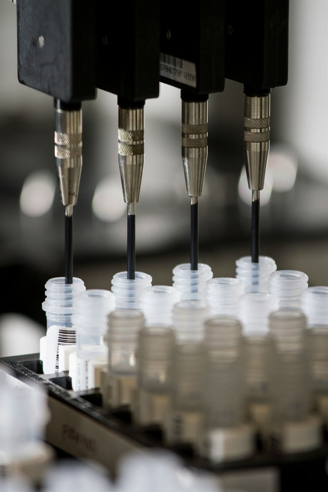 An automated pipetting machine above rows of sample tubes