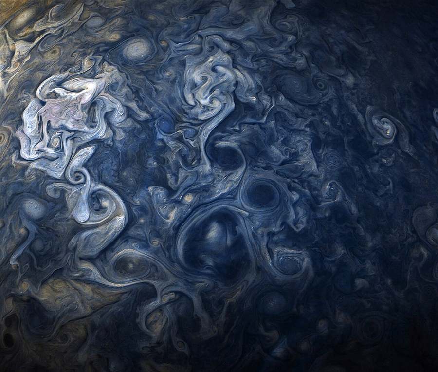Swirling blue and white storm clouds on Jupiter